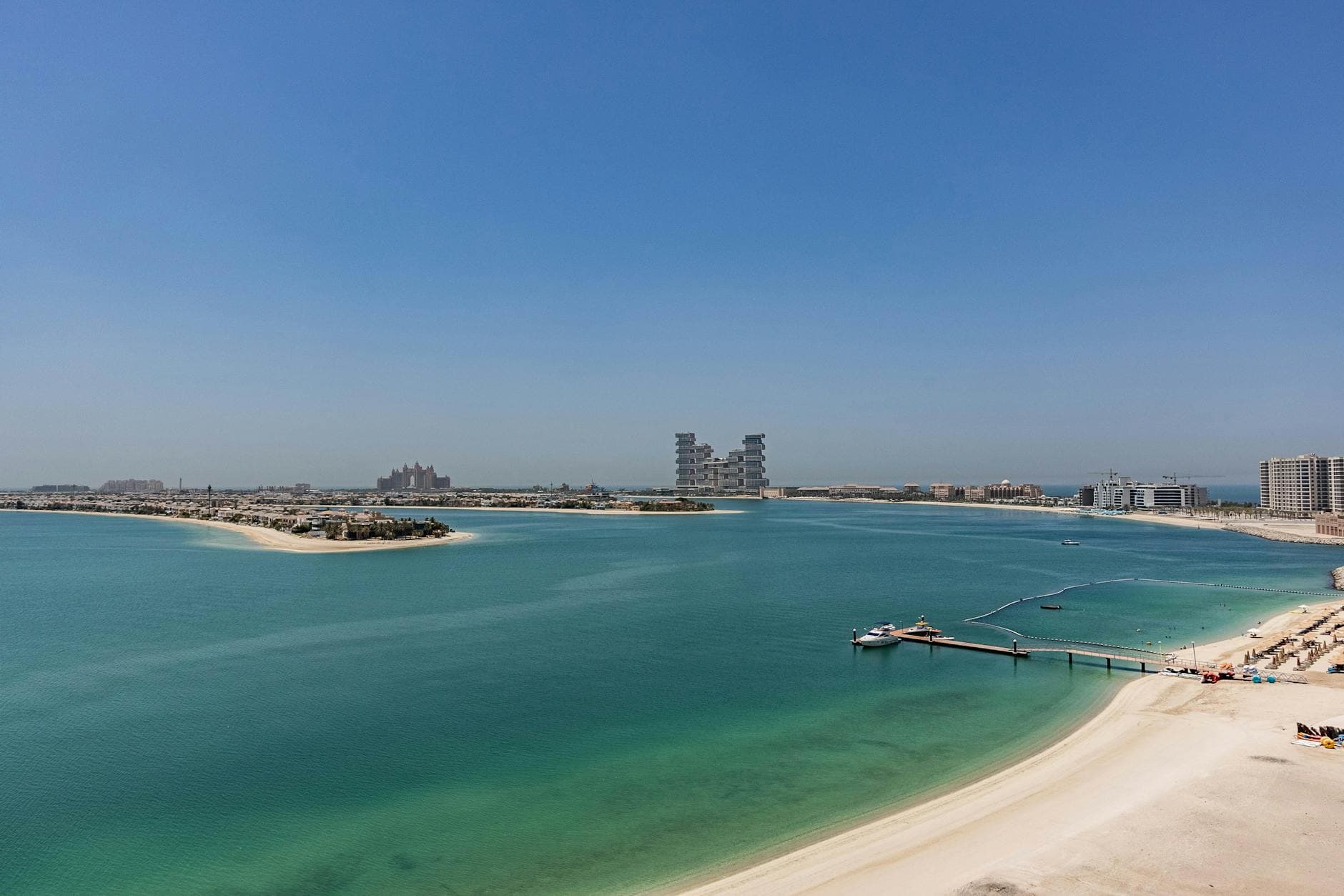 A stunning aerial view of Palm Jumeirah in Dubai, showcasing the tranquil turquoise waters and sandy beaches.