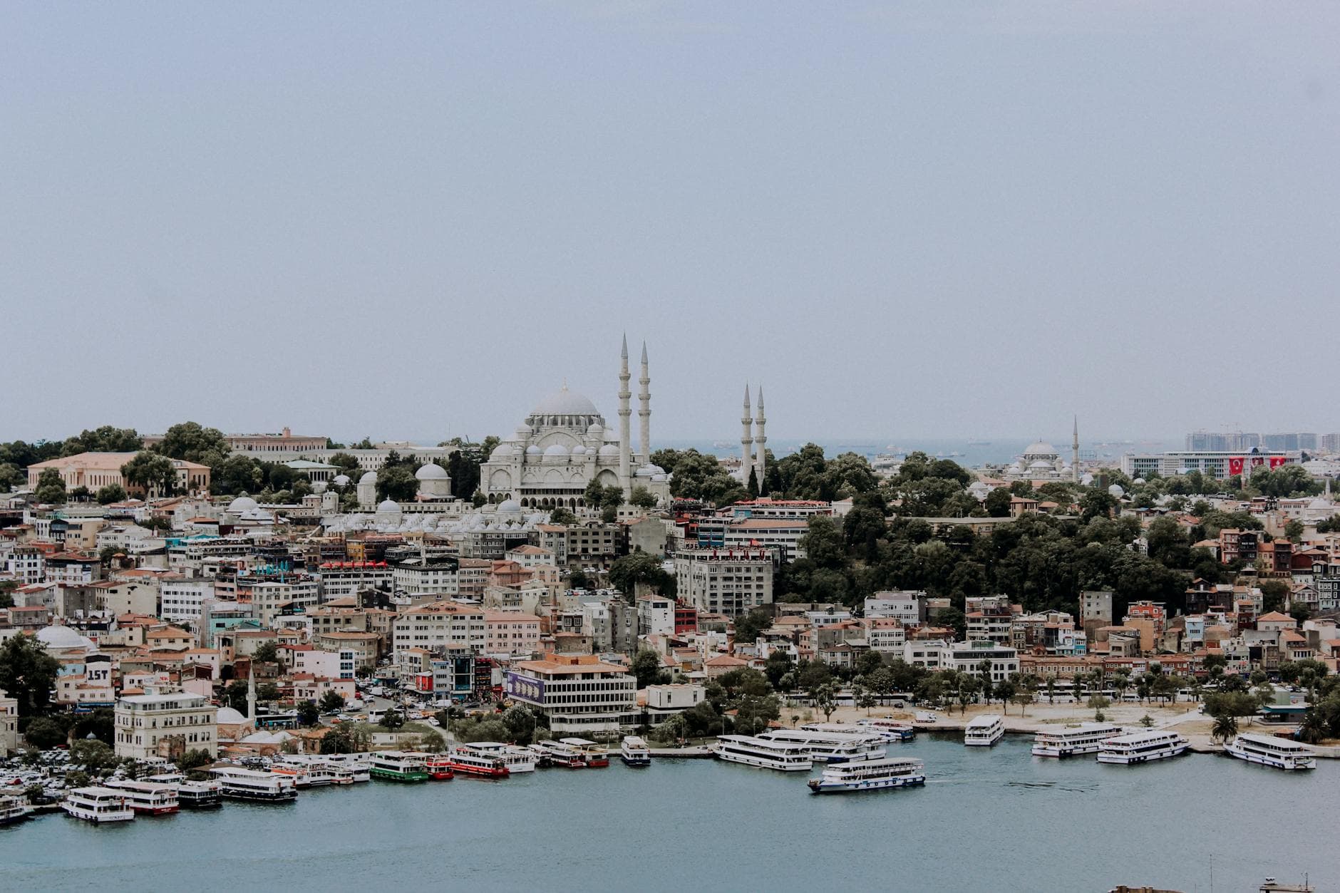 Aerial view of Istanbul's cityscape featuring the iconic Suleymaniye Mosque and Bosphorus coast.
