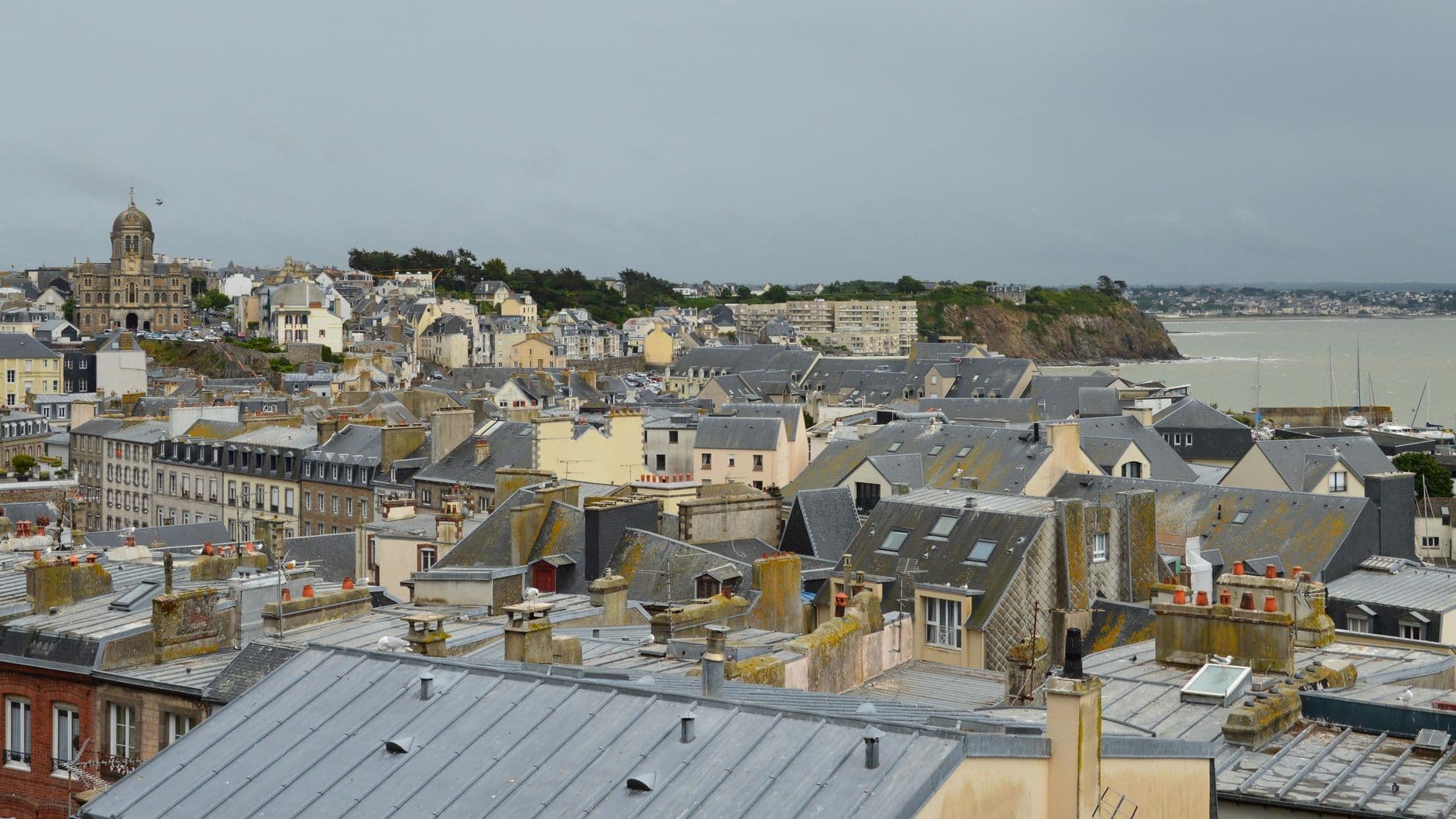 Charming view of Granville's picturesque rooftops and coastline in Normandie, France.