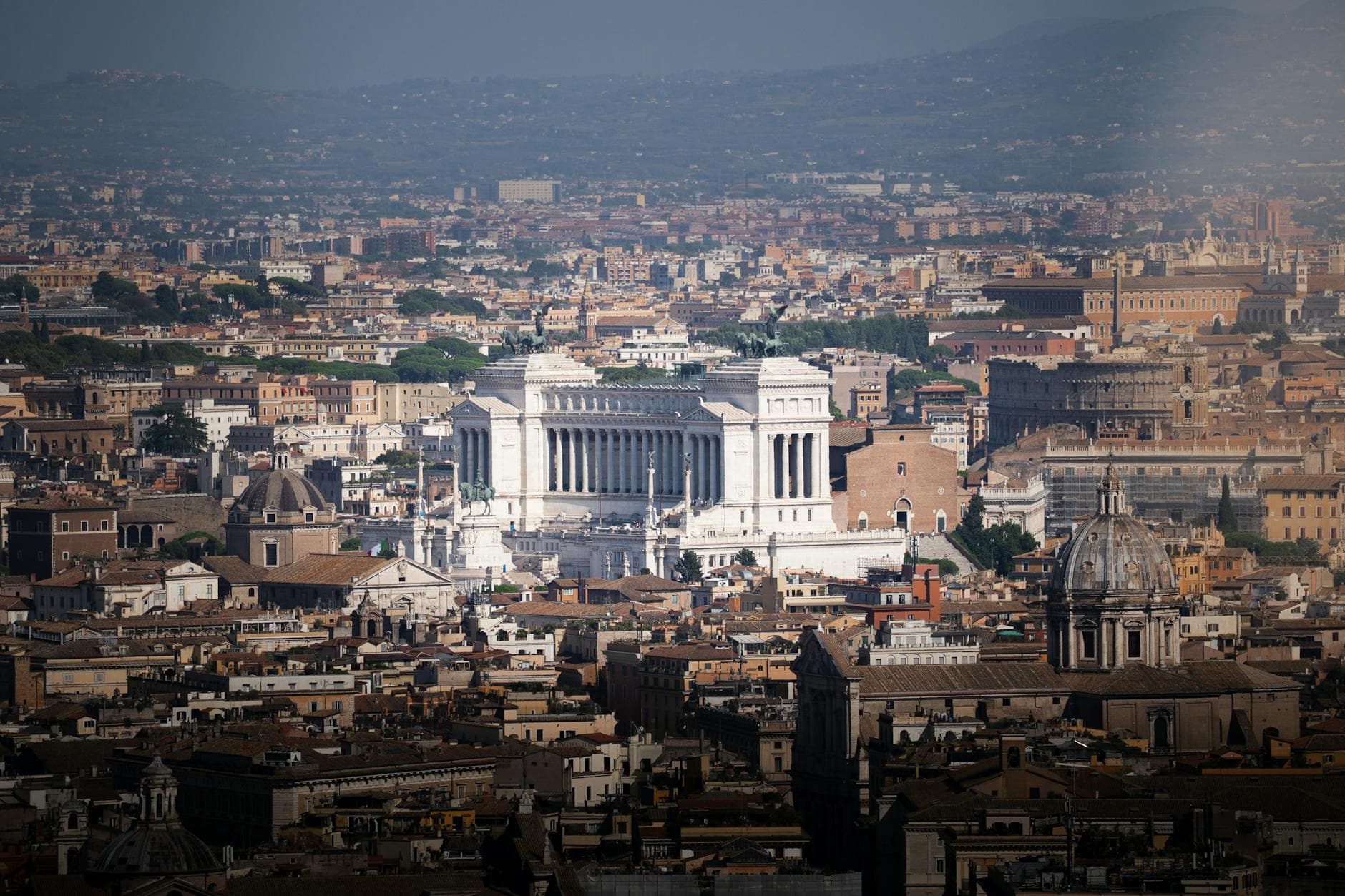 Breathtaking aerial view of Rome highlighting the iconic Vittoriano Monument amidst historic architecture.