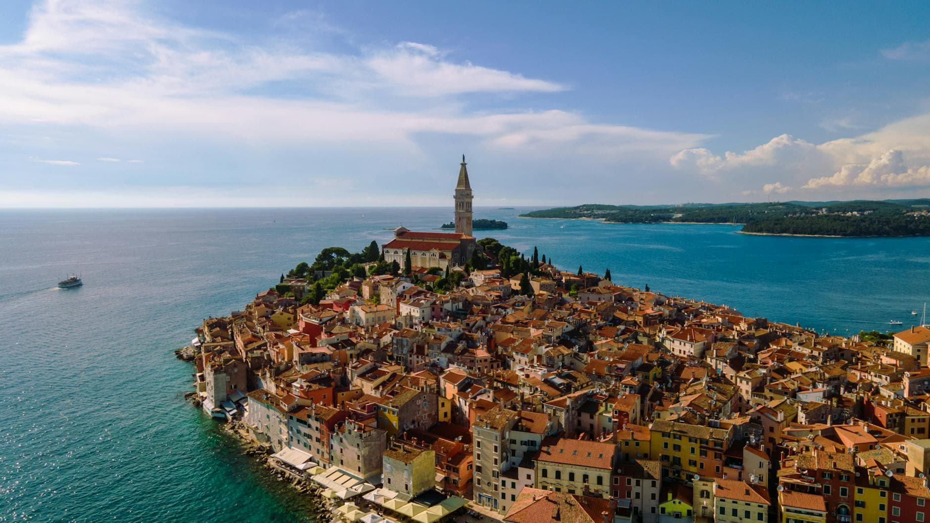 Stunning aerial view of Rovinj, Croatia, featuring charming coastal buildings and a prominent church.