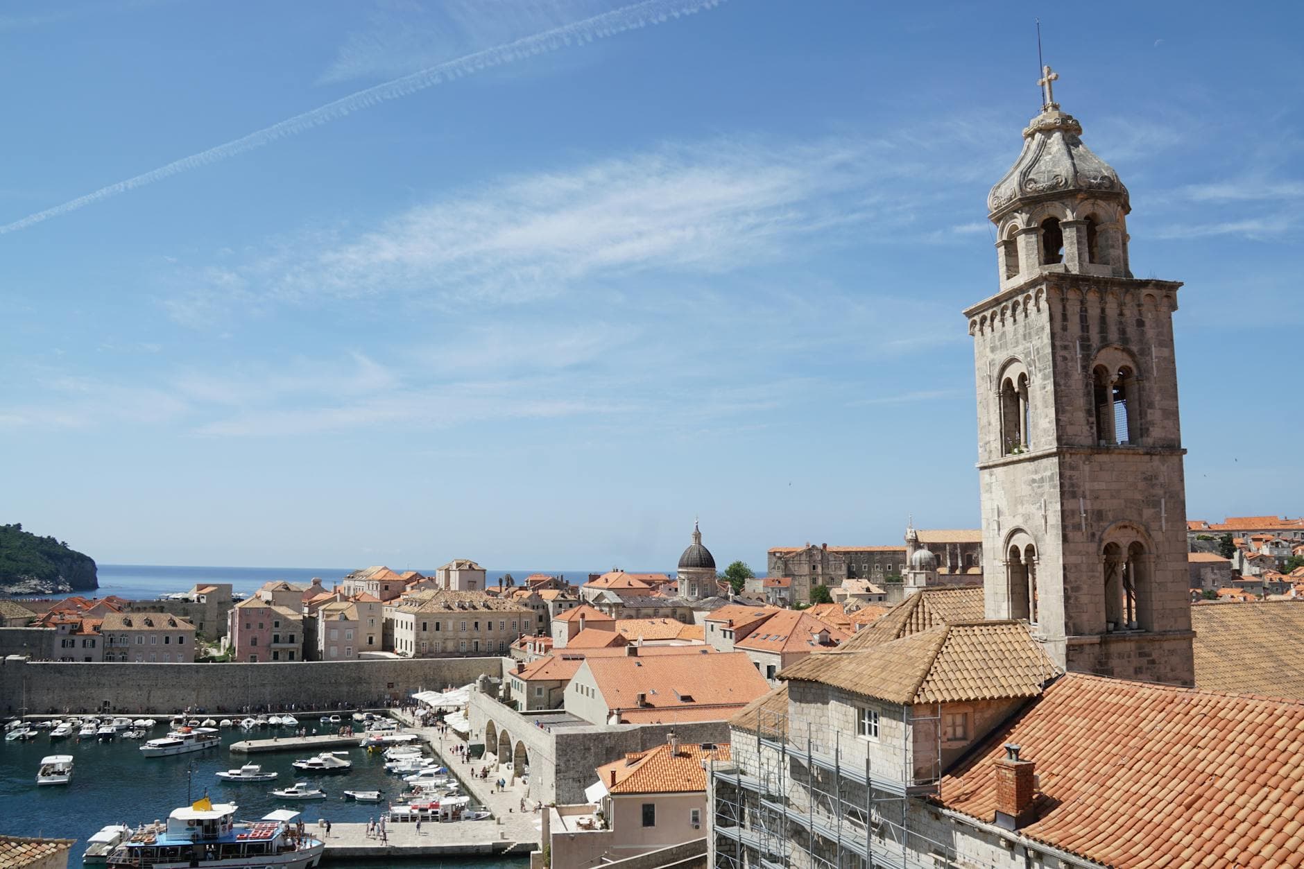 A breathtaking view of Dubrovnik's historic old town with its iconic tower and marina.