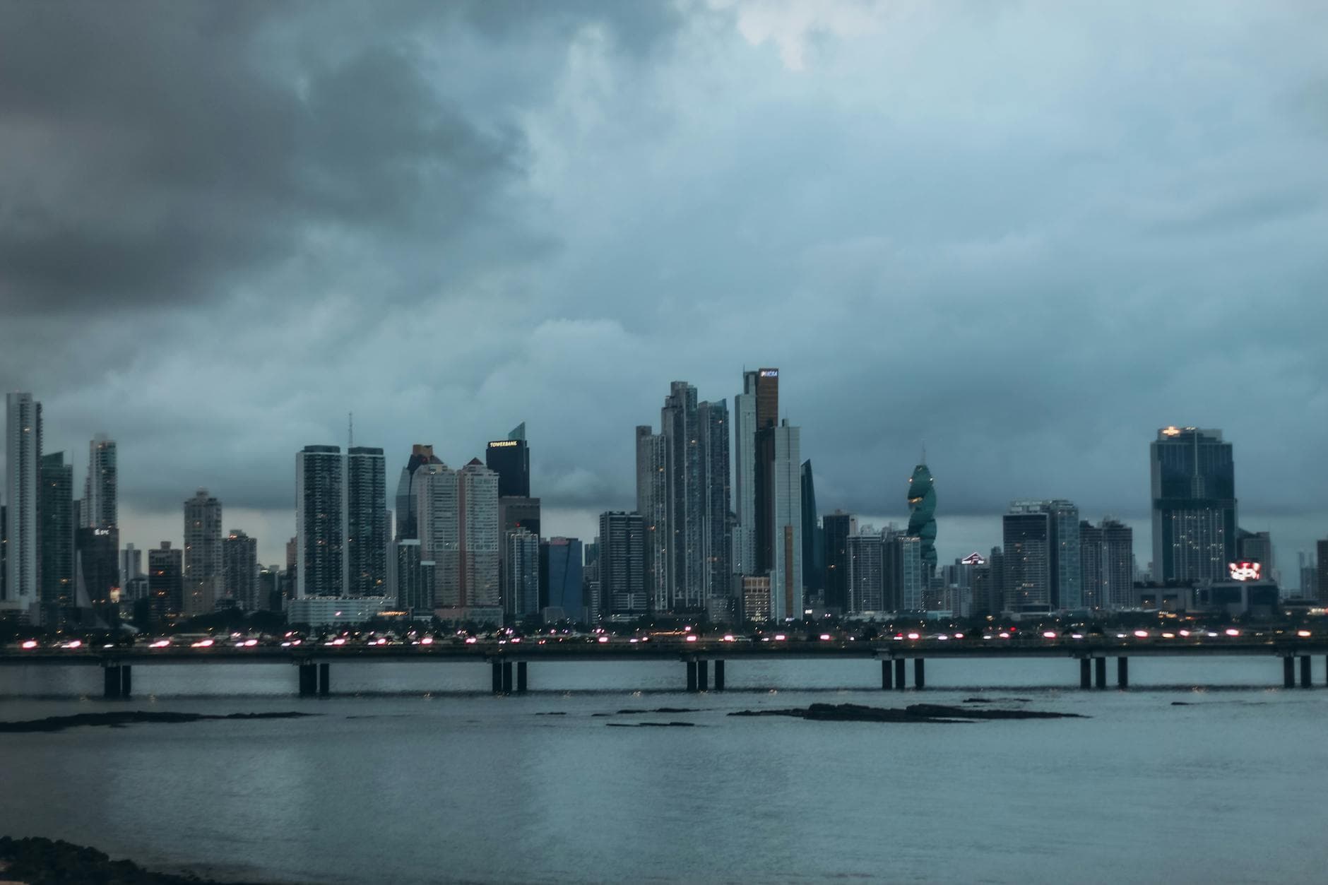 Gorgeous view of Panama City skyline with skyscrapers at twilight over the waterfront bridge.