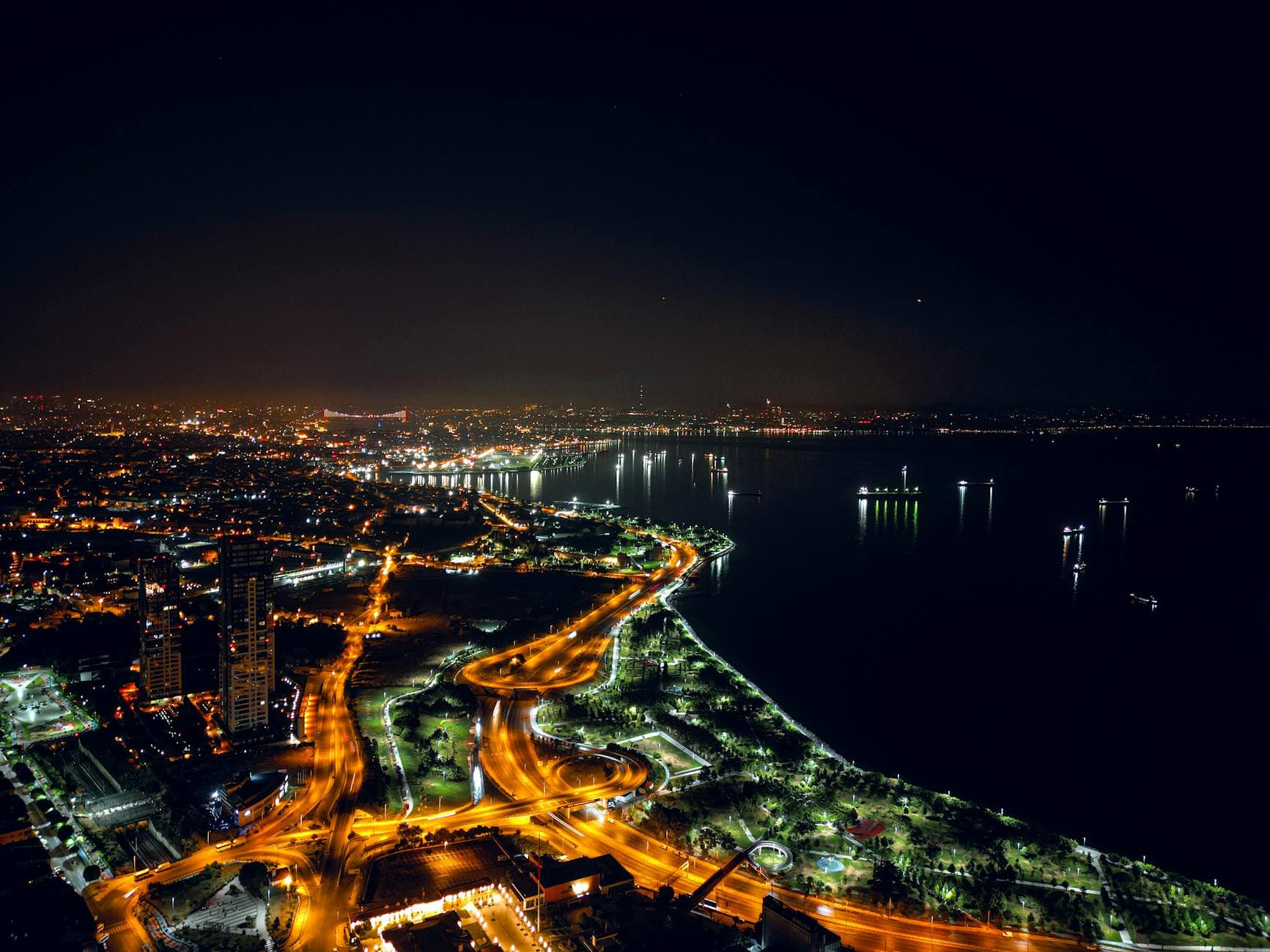 Stunning night aerial view of Zeytinburnu's illuminated waterfront in İstanbul, Türkiye.
