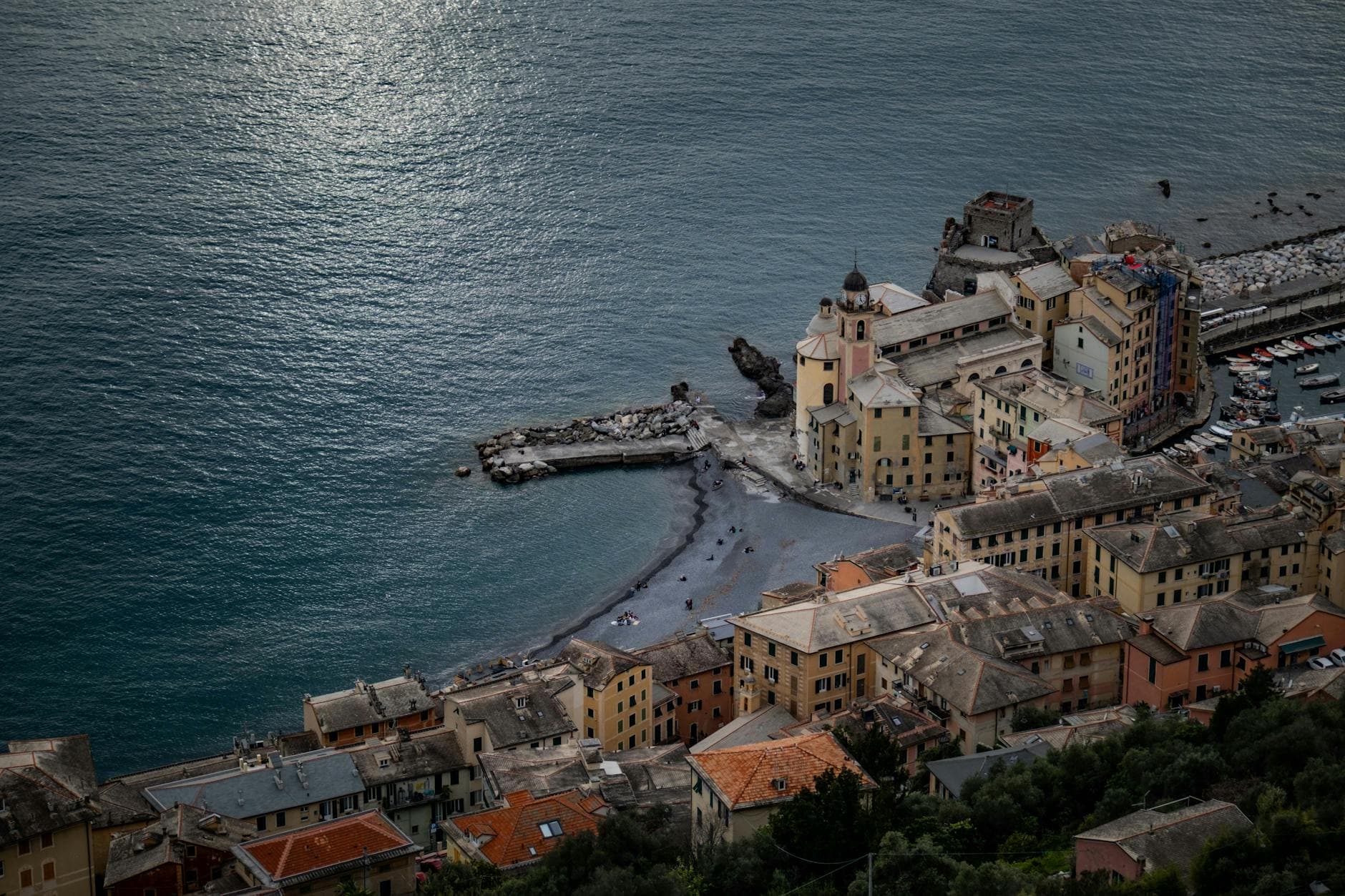 Aerial scene of historic Camogli, Italy, showcasing coastal architecture and serene Mediterranean shoreline.