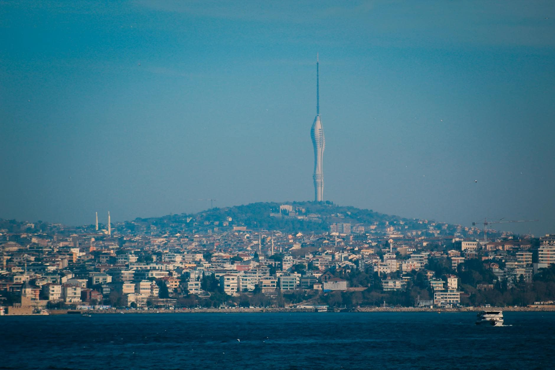 Expansive view of Istanbul cityscape with Camlica Tower rising prominently against the blue sky.