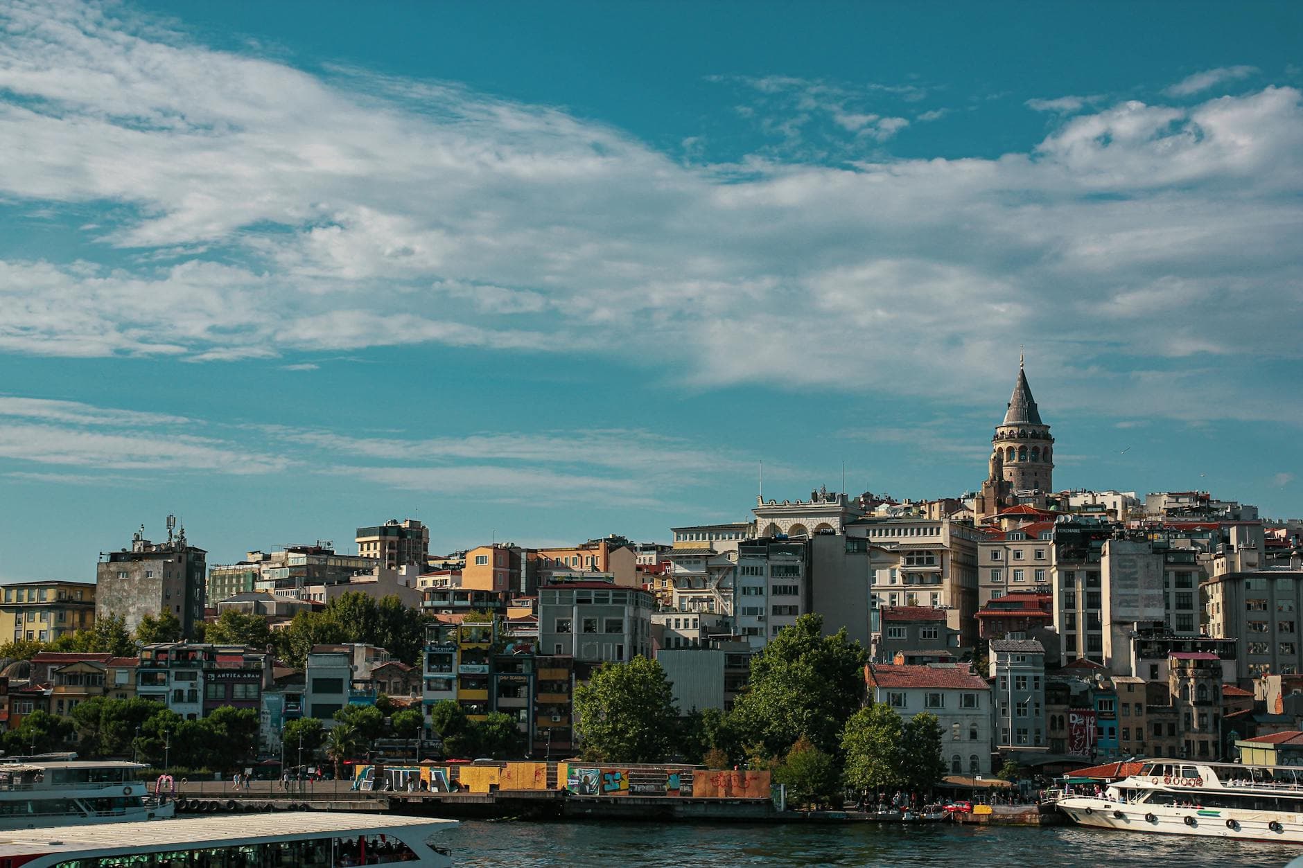 Scenic view of Istanbul's skyline featuring the iconic Galata Tower and bustling waterfront.