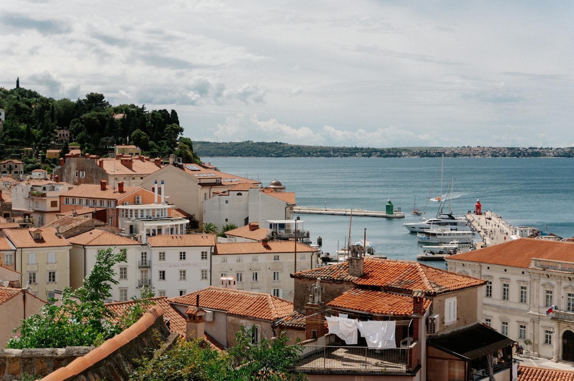 Scenic view of historic rooftops and marina in Piran, Slovenia overlooking the Adriatic Sea.