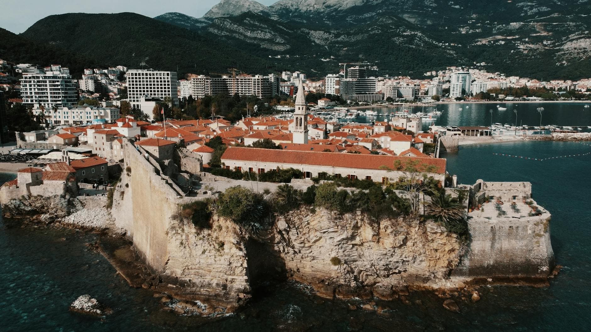 Stunning aerial view of Budva's Old Town and fortress on Montenegro's Adriatic coast.