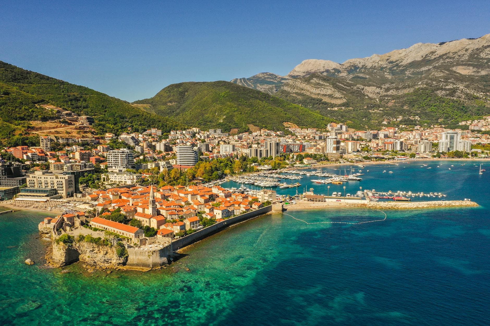 Explore Budva, Montenegro's stunning coastal cityscape, showcasing historic architecture and vibrant waterfront views.