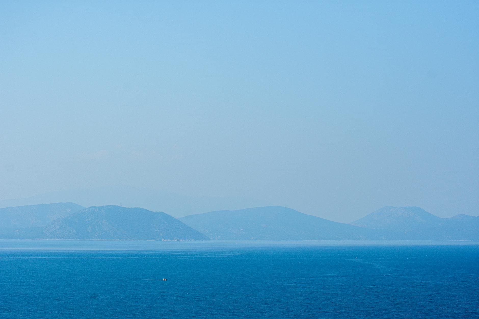 Serene view of the Aegean Sea with distant hills from Güzelçamlı, Türkiye.