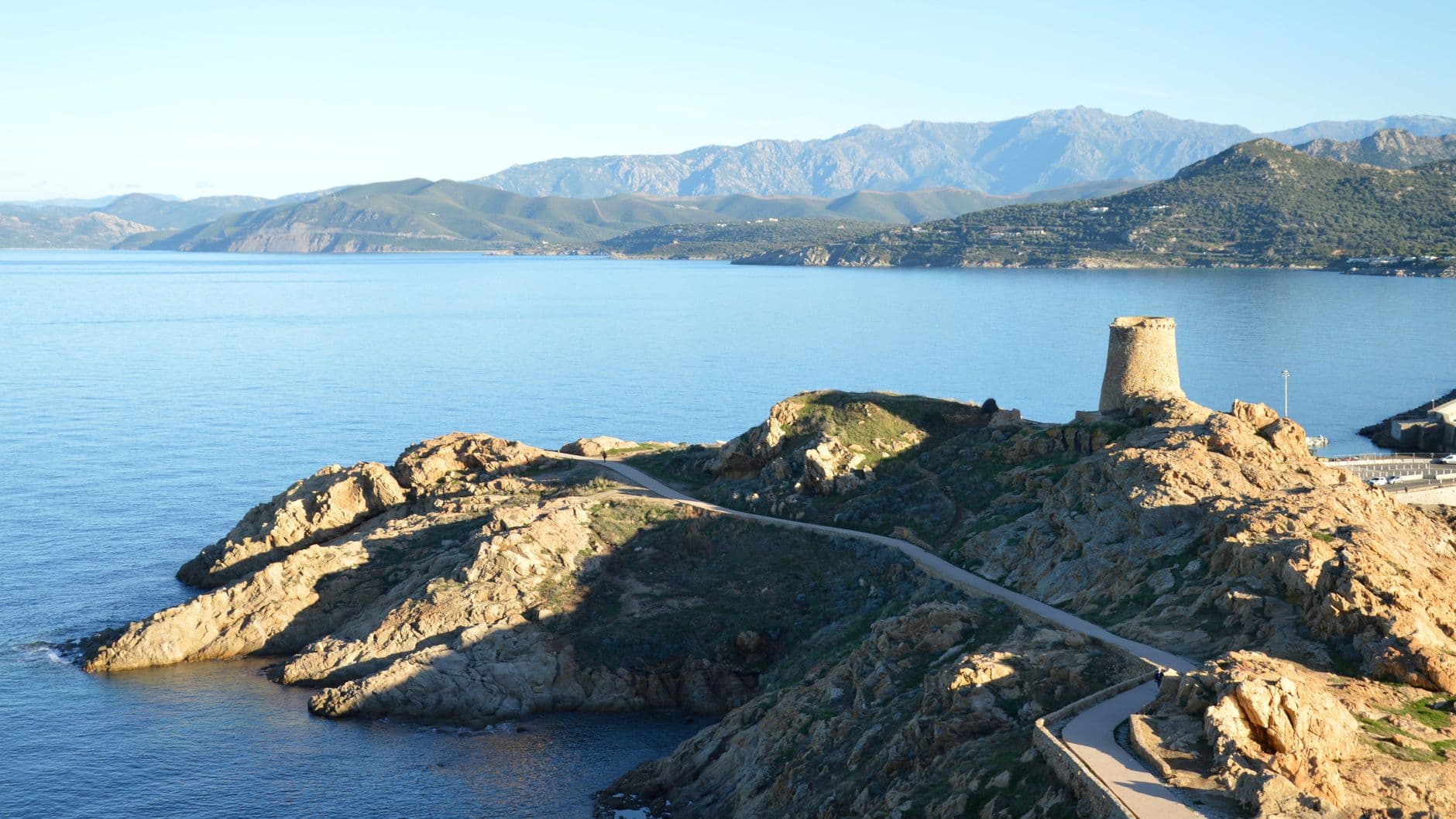 Scenic view of the Genoese tower and rocky coastline in L'Île-Rousse, Corsica.