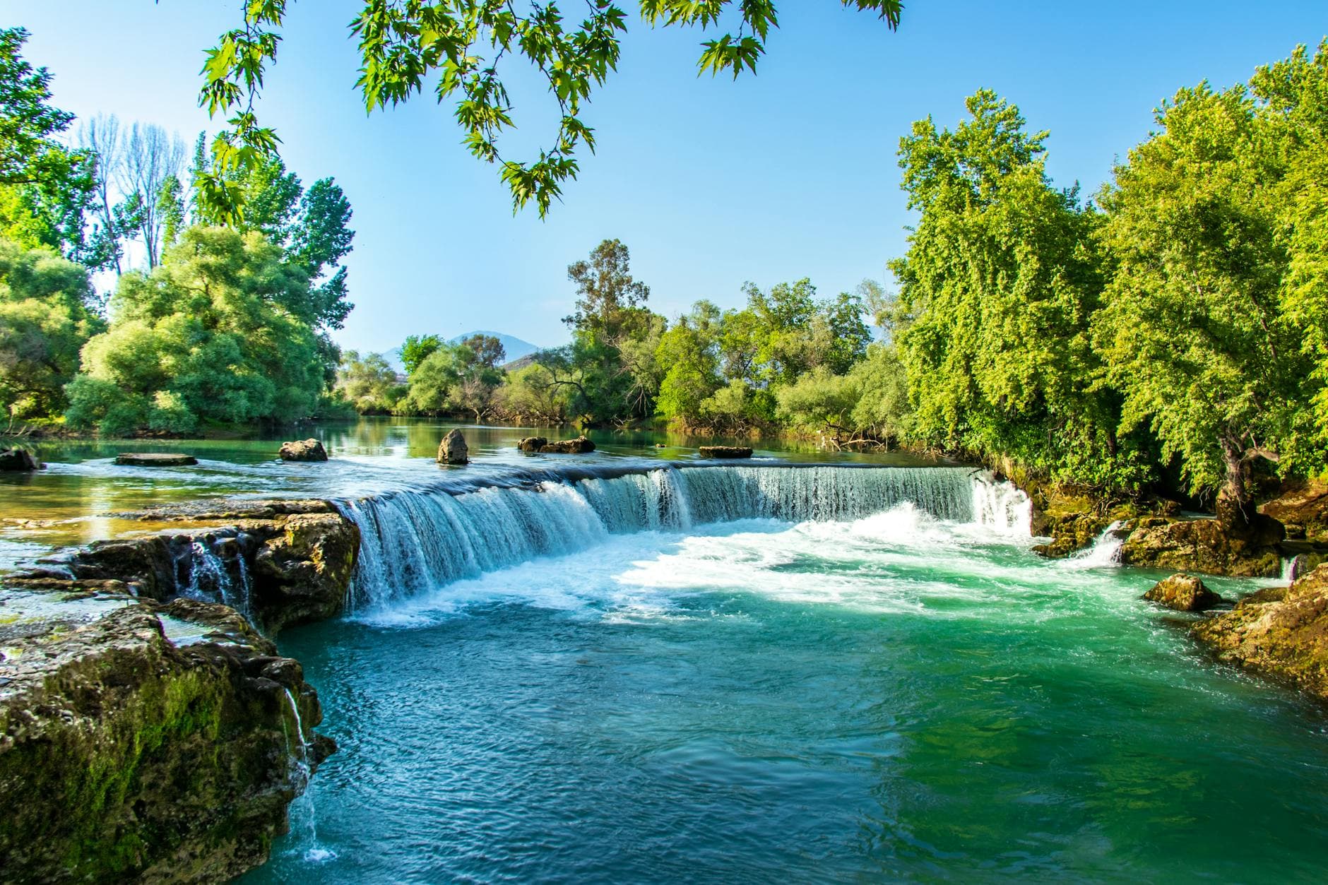Beautiful summer view of Manavgat Waterfall surrounded by lush greenery in Turkey.