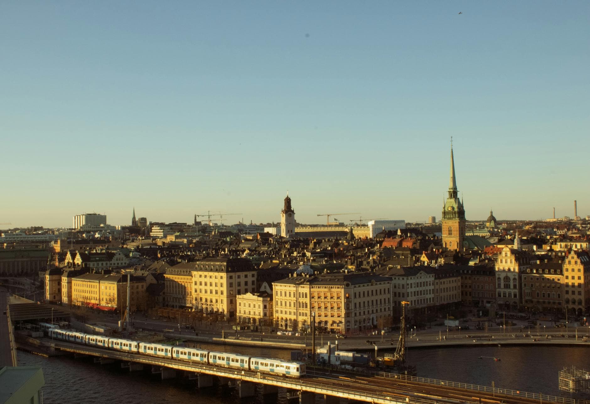 Aerial view of Stockholm's historic cityscape and waterfront during evening light.