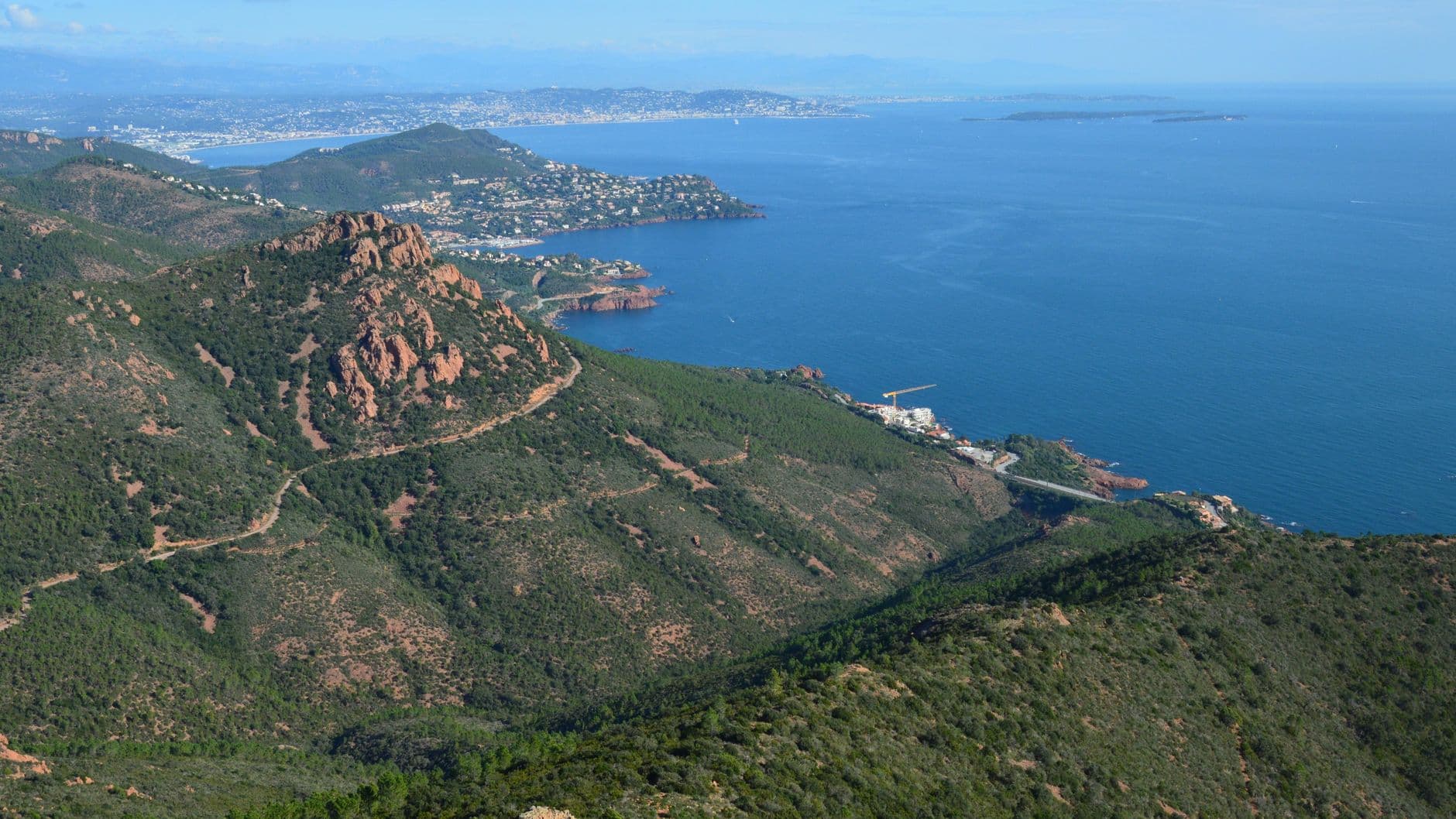 Stunning view of the Saint-Raphaël coastline in Provence, France with lush hills and blue waters.