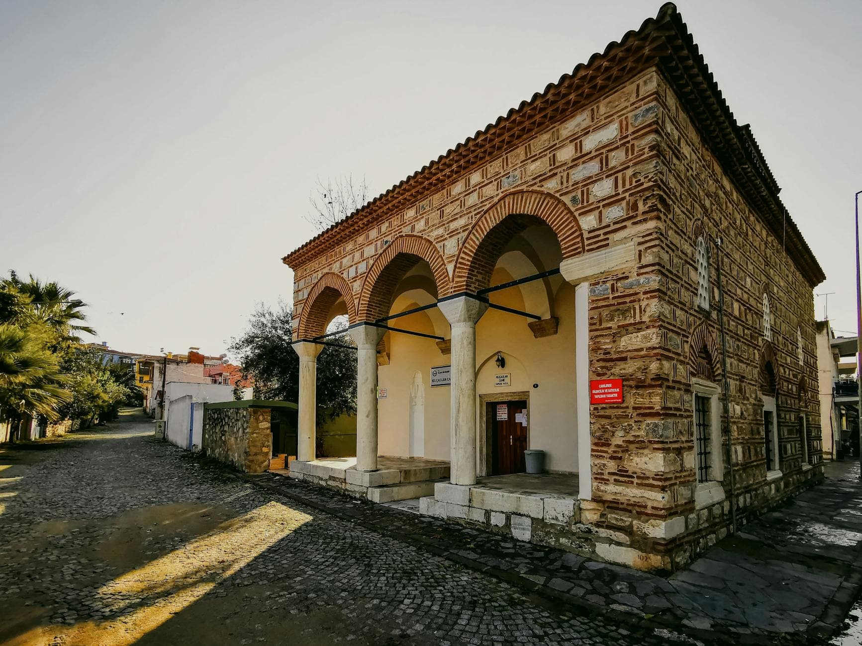 View of a historical mosque facade in Selçuk, Turkey, showcasing architecture and urban surroundings.
