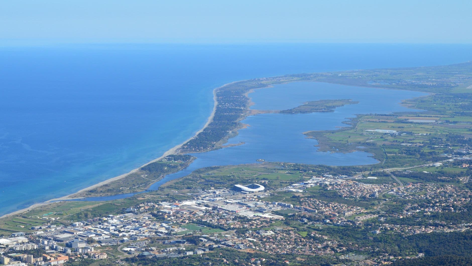 Breathtaking aerial view of Bastia's coastline and cityscape in Corsica, France.