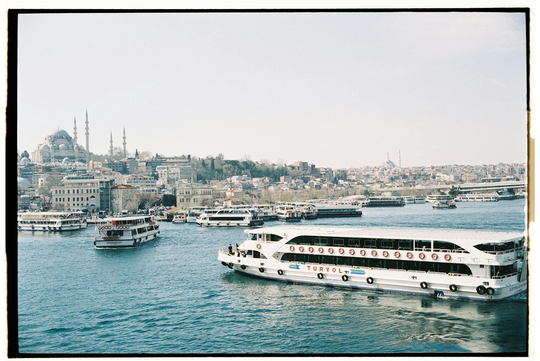 Discover Istanbul's iconic Bosphorus with ferries and historic skyline, highlighting the majestic Suleymaniye Mosque.