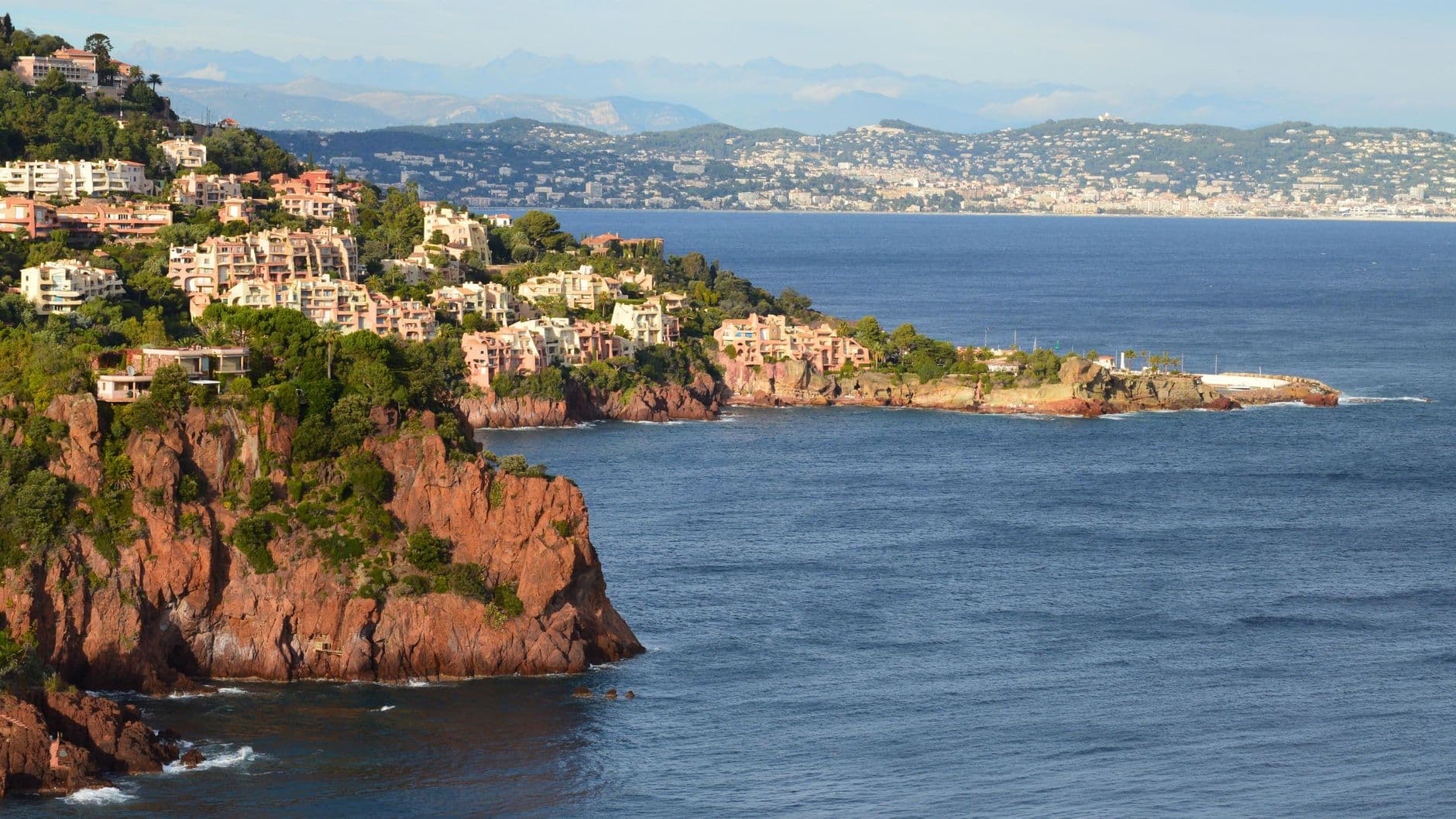 Breathtaking view of French coastal cliffs with houses facing the sea.