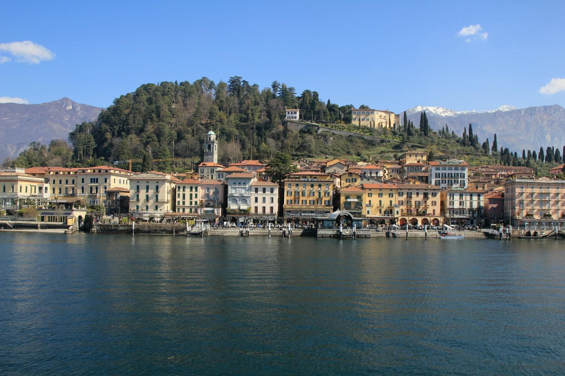 Beautiful view of Bellagio's historic waterfront with mountain backdrop, captured in springtime.